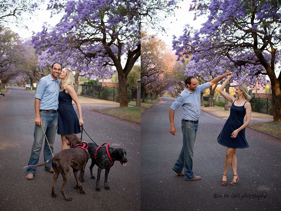jacaranda lined street with a family