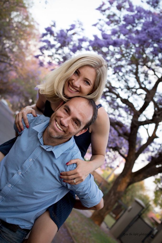 jacaranda lined street with a family