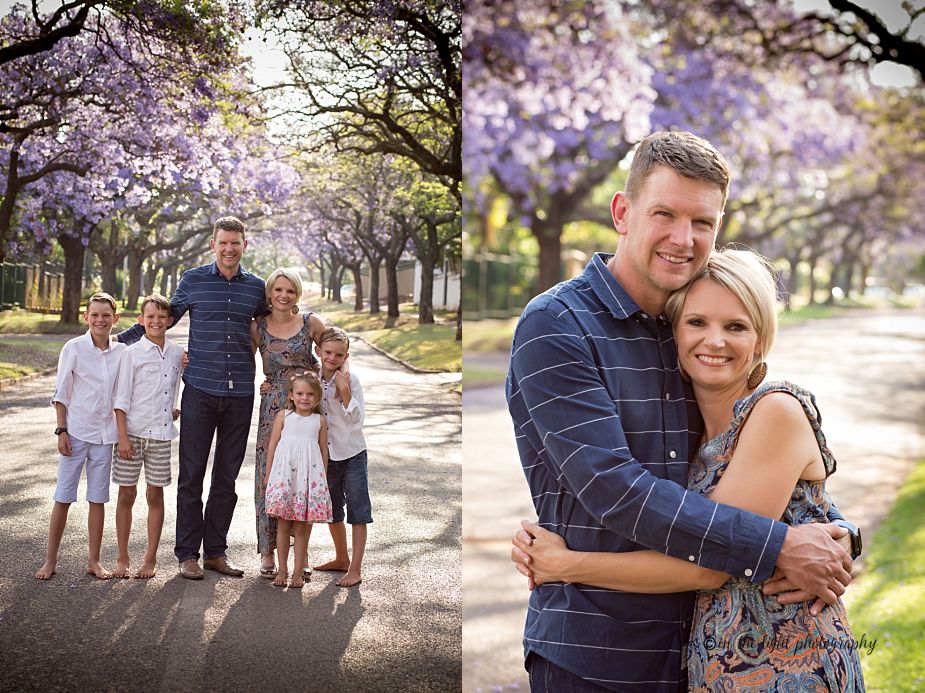 jacaranda lined street with a family