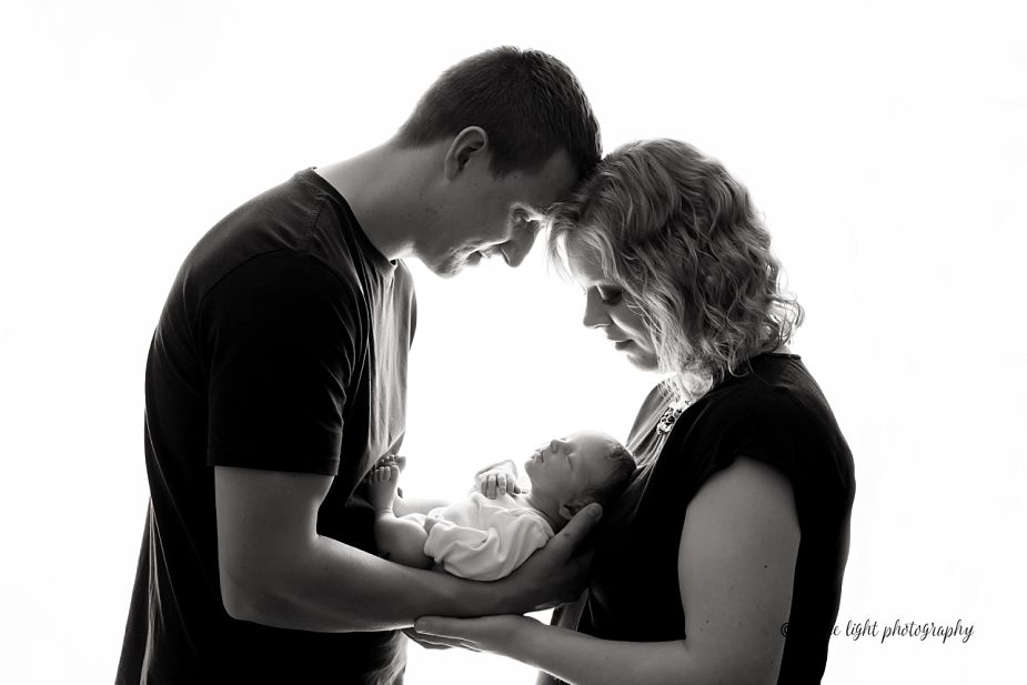 newborn baby and parents black and white high contrast image
