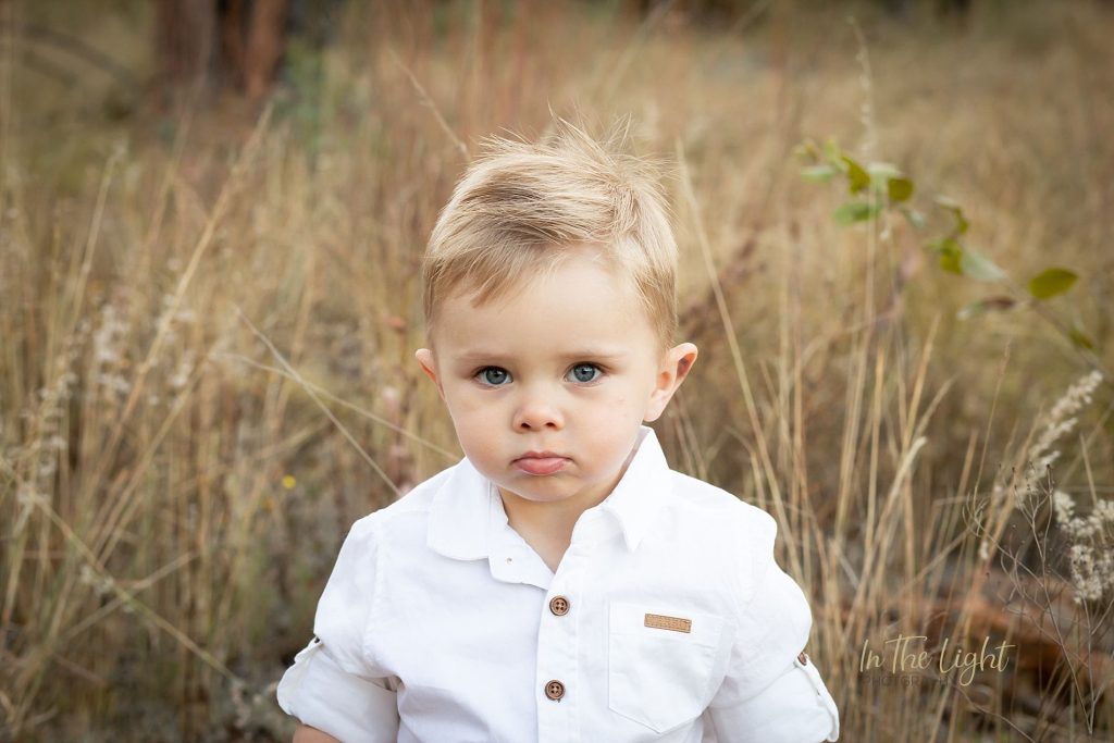 toddler boy in field