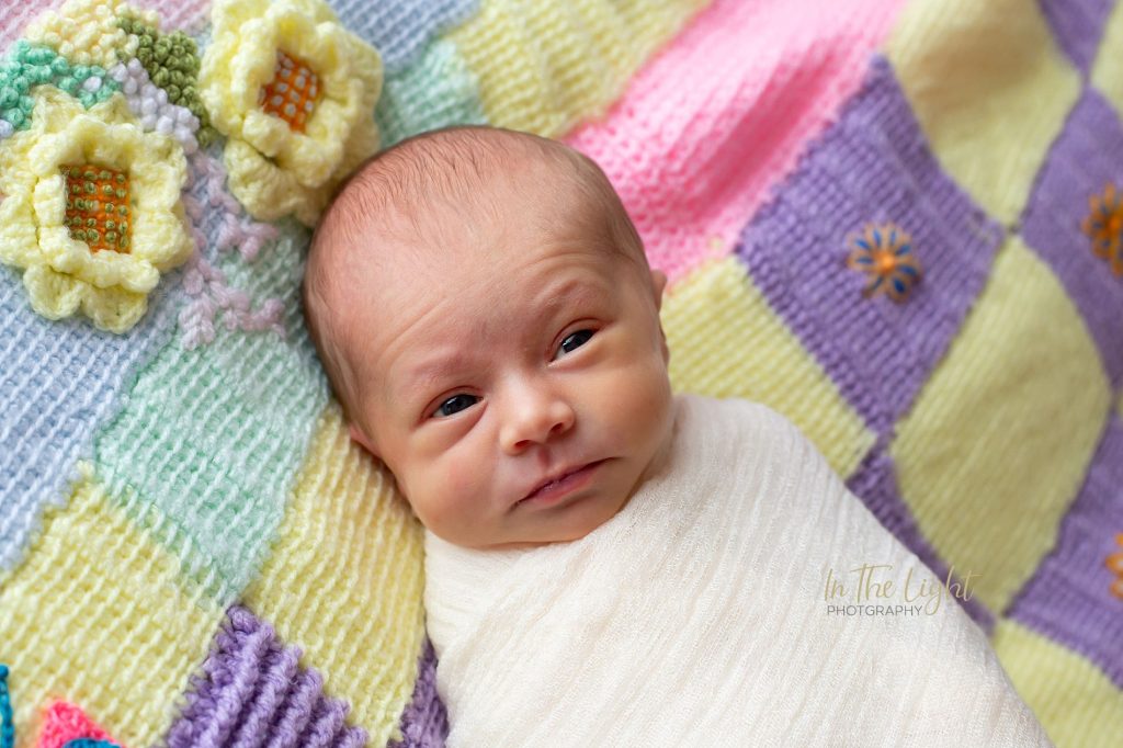 Newborn baby girl on a knitted blanket during her photo session in Centurion.