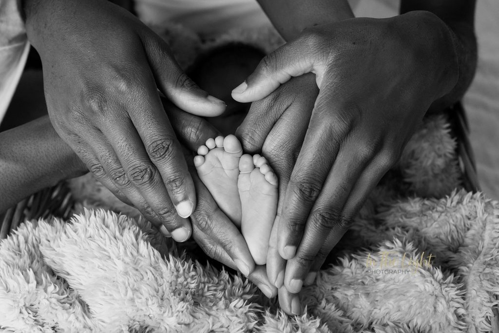 newborn baby boy and family hands