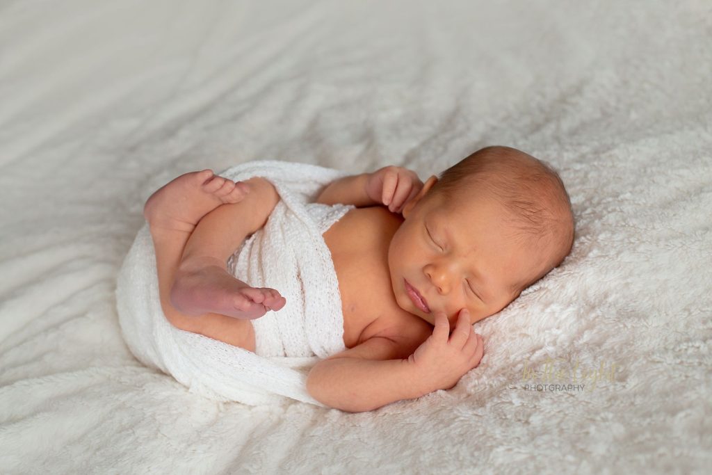 Newborn baby boy wrapped in white during his newborn session in Centurion.