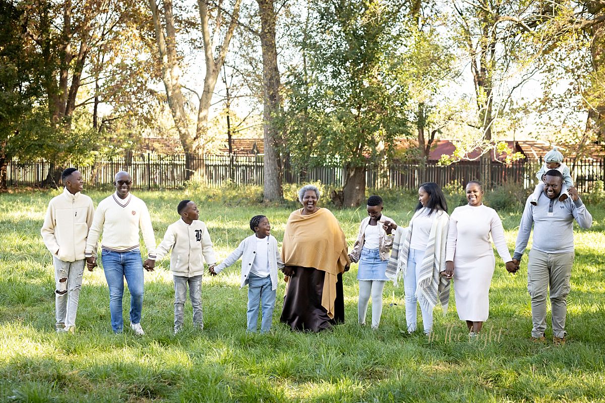 Extended family walking in a field at Irene Dairy farm.
