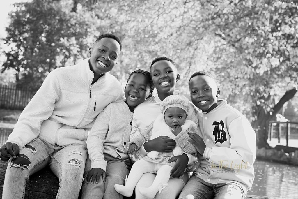 Cousins laughing together during their recent family photo session at Irene Dairy Farm.