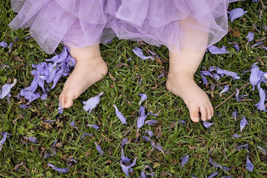 Baby feet and Jacaranda blooms in the streets of Pretoria.