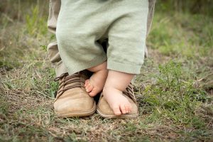 Baby feet on top of dad's feet at Faerie Glen nature reserve in Pretoria East