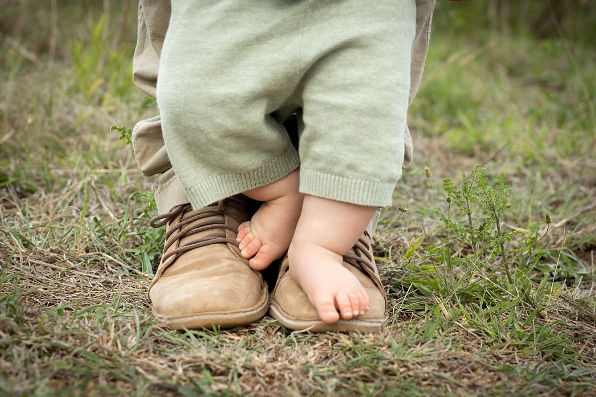 Baby feet on top of dad's feet at Faerie Glen nature reserve in Pretoria East